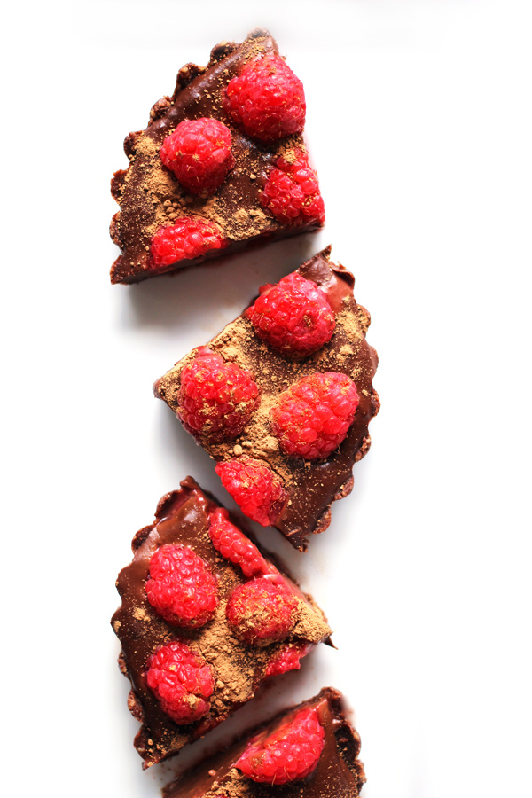 These deliciously sinful, No Bake Chocolate Raspberry Tarts are filled with sweet vegan chocolate and topped with summers brightest berries. A dessert whipped up in minutes and eaten in seconds. NeuroticMommy.com #vegan #chocolate #nobake