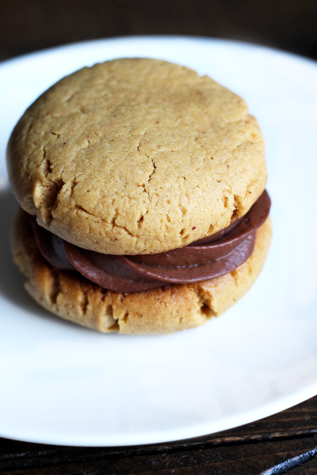 Chocolate Peanut Butter Sandwich Cookies filled with a sexy creamy chocolate and surrounded by soft, chewy, peanutty cookies. NeuroticMommy.com #vegan #healthy #cookies