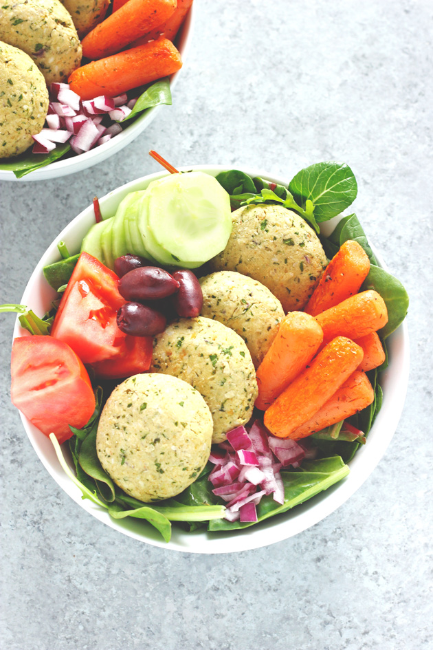 Mediterranean Infused Bliss Bowls - Delectable bowls loaded with falafel, leafy greens, roasted carrots, red onion, tomato, kalamata olives, and cucumbers. Perfectly filling, perfectly healthy. NeuroticMommy.com #vegan #healthy