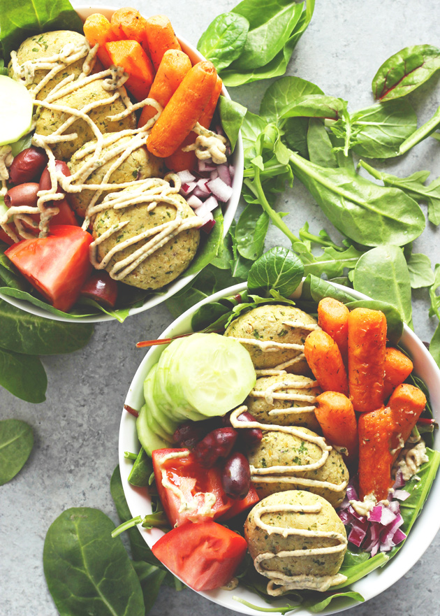 Mediterranean Infused Bliss Bowls - Delectable bowls loaded with falafel, leafy greens, roasted carrots, red onion, tomato, kalamata olives, and cucumbers. Perfectly filling, perfectly healthy. NeuroticMommy.com #vegan #healthy