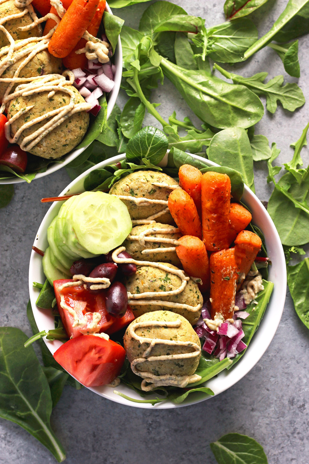 Mediterranean Infused Bliss Bowls - Delectable bowls loaded with falafel, leafy greens, roasted carrots, red onion, tomato, kalamata olives, and cucumbers. Perfectly filling, perfectly healthy. NeuroticMommy.com #vegan #healthy