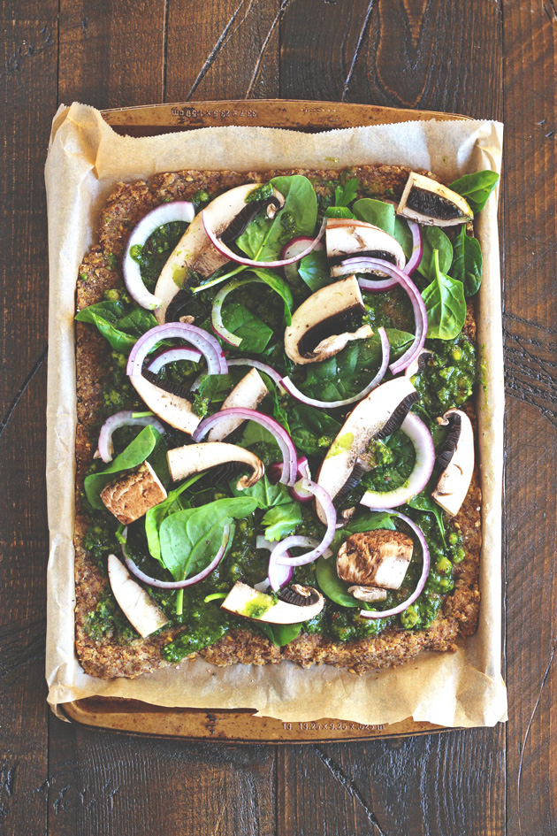 This pizza will hit the spot, it's satisfying, with the right amount of pesto and flavor. Jam packed with nutrients and one of many meals to share with the family after holidays full of sweets. NeuroticMommy.com #vegan #raw #healthy #pizza