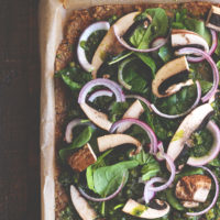 This pizza will hit the spot, it's satisfying, with the right amount of pesto and flavor. Jam packed with nutrients and one of many meals to share with the family after holidays full of sweets. NeuroticMommy.com #vegan #raw #healthy #pizza