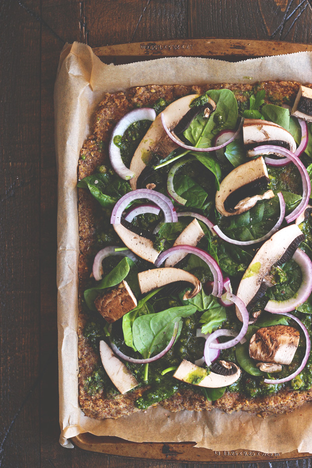 This pizza will hit the spot, it's satisfying, with the right amount of pesto and flavor. Jam packed with nutrients and one of many meals to share with the family after holidays full of sweets. NeuroticMommy.com #vegan #raw #healthy #pizza