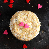 Valentine's Day Toasted Coconut Doughnuts - Fluffy cream filled doughnuts topped with a toasted coconut and hearts. Perfect for Valentine's Day! NeuroticMommy.com #vegan #valentinesday #donuts