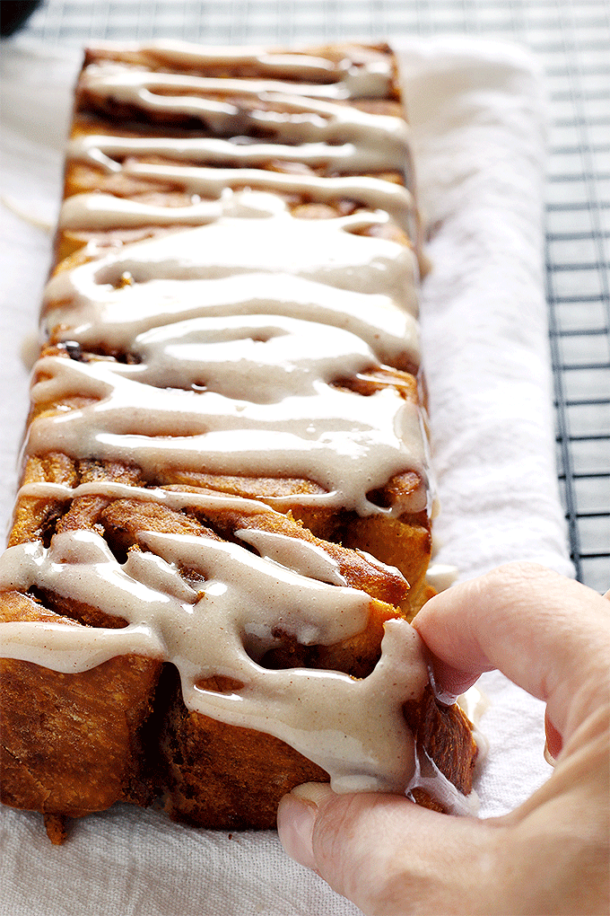 Pumpkin Pull Apart Bread - the perfect comforting snack to kick off fall season with. Drizzled with pumpkin spice icing, you cannot go wrong! NeuroticMommy.com #vegan #fall #breads