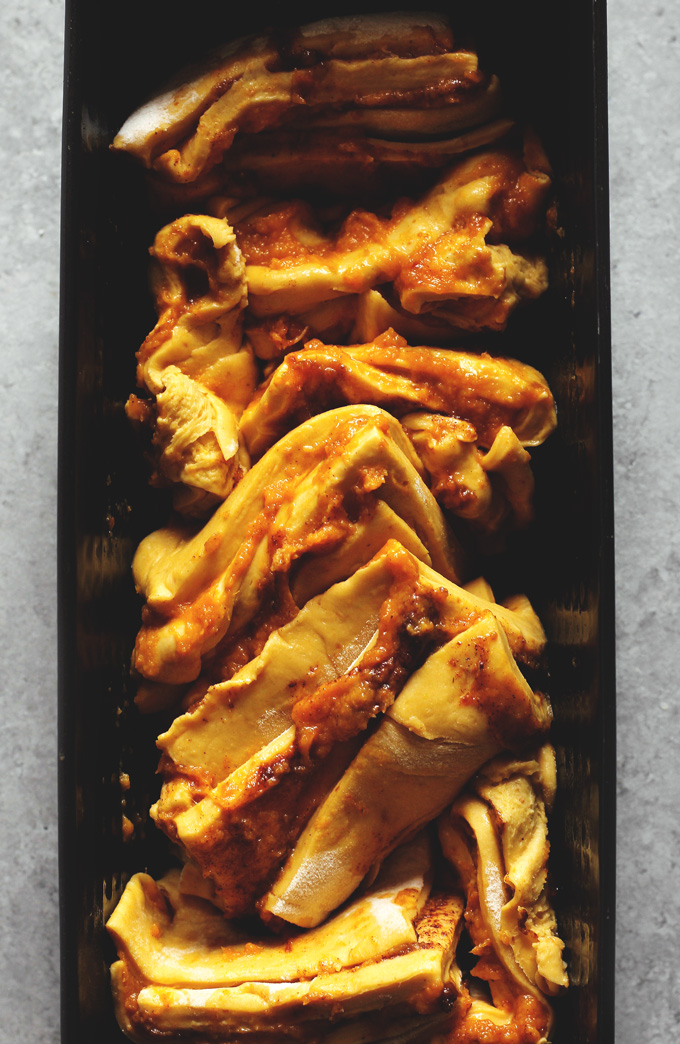 Pumpkin Pull Apart Bread - the perfect comforting snack to kick off fall season with. Drizzled with pumpkin spice icing, you cannot go wrong! NeuroticMommy.com #vegan #fall #breads