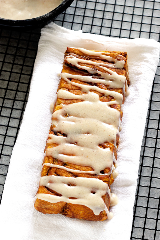 Pumpkin Pull Apart Bread - the perfect comforting snack to kick off fall season with. Drizzled with pumpkin spice icing, you cannot go wrong! NeuroticMommy.com #vegan #fall #breads