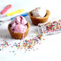 Chocolate Chip Cookie Cup Sundae - Have fun and get romantic with these chocolate chip cookie cups. Topped with #vegan ice cream and chocolate sauce...you don't want to miss out. Super easy to make! NeuroticMommy.com #desserts #valentinesday