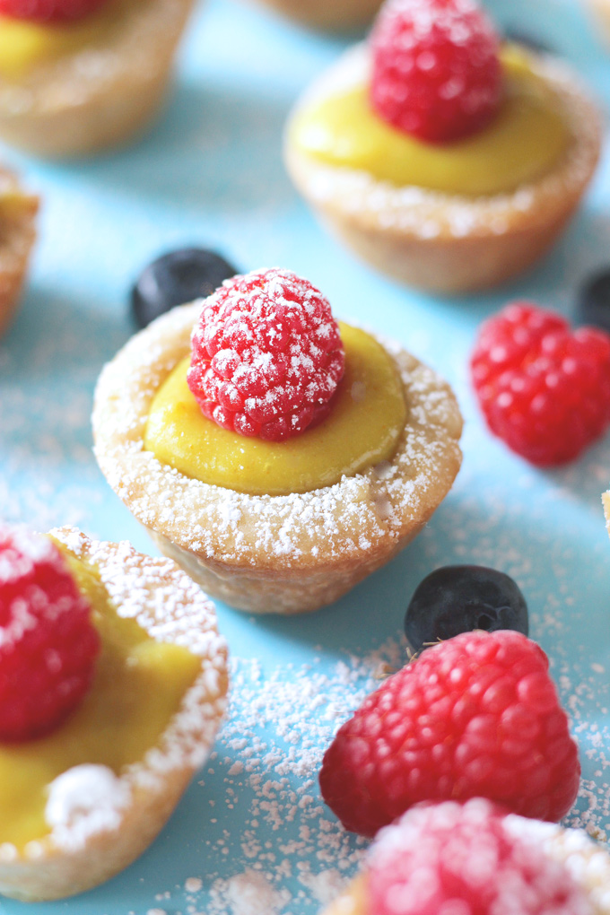 Mini Vegan Custard Tarts With Raspberry - These tarts are made with a cake crust and filled with a creamy, dreamy, heavenly vegan custard. Topped off with fresh raspberries and powdered coconut shreds for extra sparkle, making these bites sugar freakin' free! NeuroticMommy.com #vegan #healthysnacks