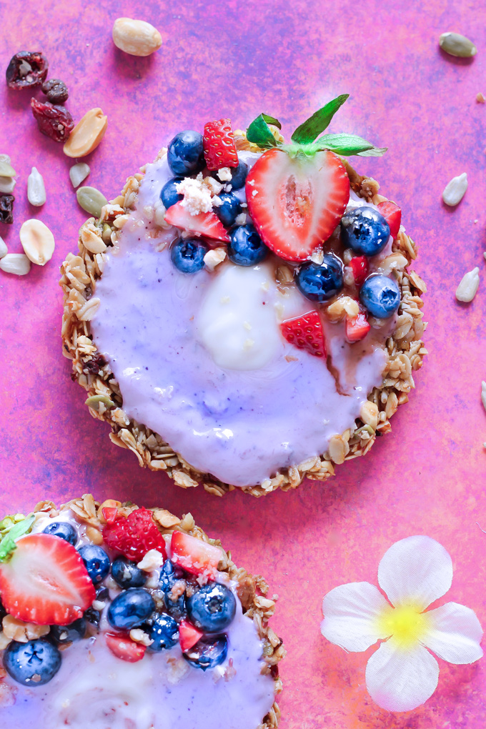 Nut and Seed Fruit Yogurt Tarts [Vegan] - These tarts not only look super pretty, they are filled with vegan blueberry yogurt and surrounded by an array of delicious mixed nuts like walnuts, almonds, sunflower seeds and peanuts. Add some fresh berries on top and enjoy this sweet treat as breakfast, snack or dessert. NeuroticMommy.com #healthy #vegan #easter #tarts 