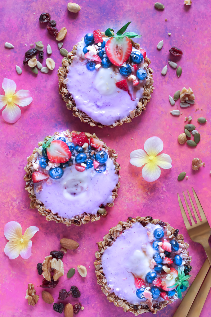 Nut and Seed Fruit Yogurt Tarts [Vegan] - These tarts not only look super pretty, they are filled with vegan blueberry yogurt and surrounded by an array of delicious mixed nuts like walnuts, almonds, sunflower seeds and peanuts. Add some fresh berries on top and enjoy this sweet treat as breakfast, snack or dessert. NeuroticMommy.com #healthy #vegan #easter #tarts 