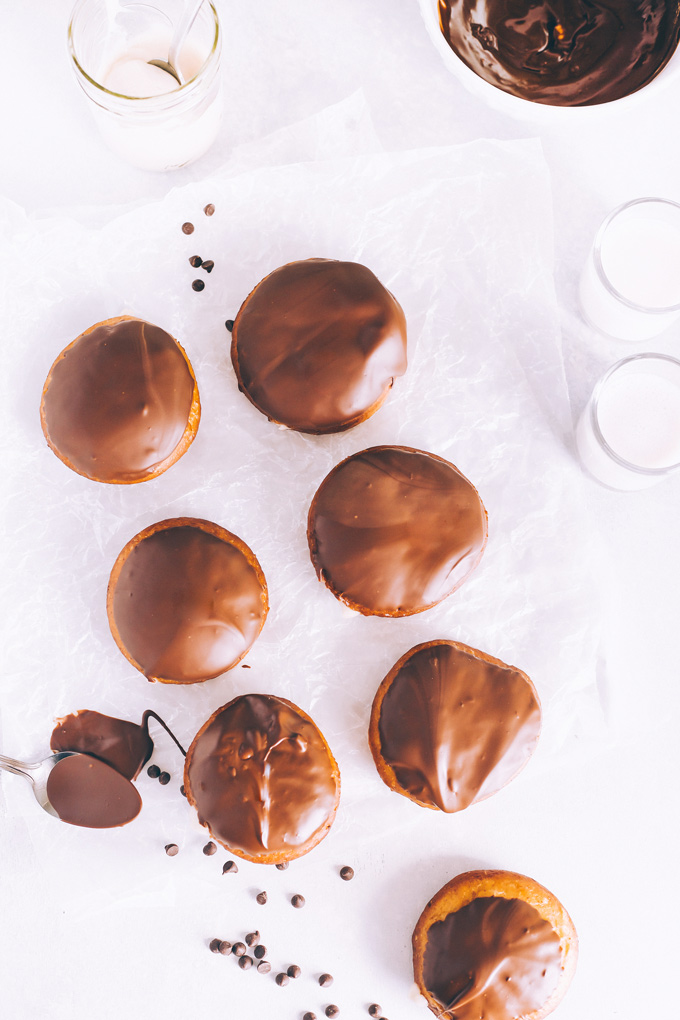 Vegan Boston Cream Doughnuts - These are generously filled with creamy vanilla custard and coated in a thick layer of dairy free chocolate making them a snack must have! NeuroticMommy.com #vegan #bostoncream