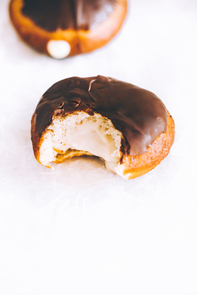 Vegan Boston Cream Doughnuts - These are generously filled with creamy vanilla custard and coated in a thick layer of dairy free chocolate making them a snack must have! NeuroticMommy.com #vegan #bostoncream