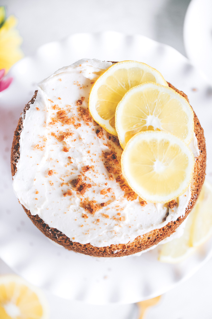 This spectacular Vegan Lemon Cream Layer Cake is a delectable cake for the most special of occasions. Enjoy the creamy lemon buttercream sandwiched between layers of homemade vanilla cake. NeuroticMommy.com #vegan #cake #easter