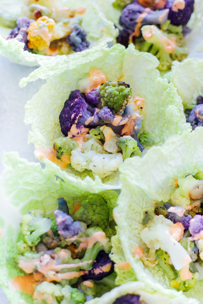 Roasted Cauliflower Cabbage Wraps - Rainbow cauliflower roasted then wrapped in savoy cabbage. Drizzle on some avocado cream or vegan thousand island dressing for added flavor. Super colorful, super delicious, super healthy. NeuroticMommy.com #cabbage #cauliflower #wraps #vegan