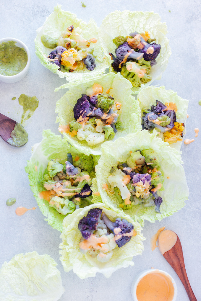 Roasted Cauliflower Cabbage Wraps - Rainbow cauliflower roasted then wrapped in savoy cabbage. Drizzle on some avocado cream or vegan thousand island dressing for added flavor. Super colorful, super delicious, super healthy. NeuroticMommy.com #cabbage #cauliflower #wraps #vegan