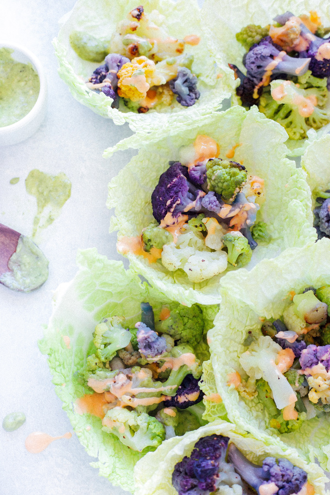 Roasted Cauliflower Cabbage Wraps - Rainbow cauliflower roasted then wrapped in savoy cabbage. Drizzle on some avocado cream or vegan thousand island dressing for added flavor. Super colorful, super delicious, super healthy. NeuroticMommy.com #cabbage #cauliflower #wraps #vegan