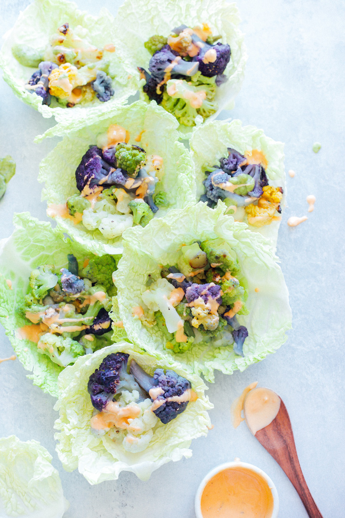 Roasted Cauliflower Cabbage Wraps - Rainbow cauliflower roasted then wrapped in savoy cabbage. Drizzle on some avocado cream or vegan thousand island dressing for added flavor. Super colorful, super delicious, super healthy. NeuroticMommy.com #cabbage #cauliflower #wraps #vegan
