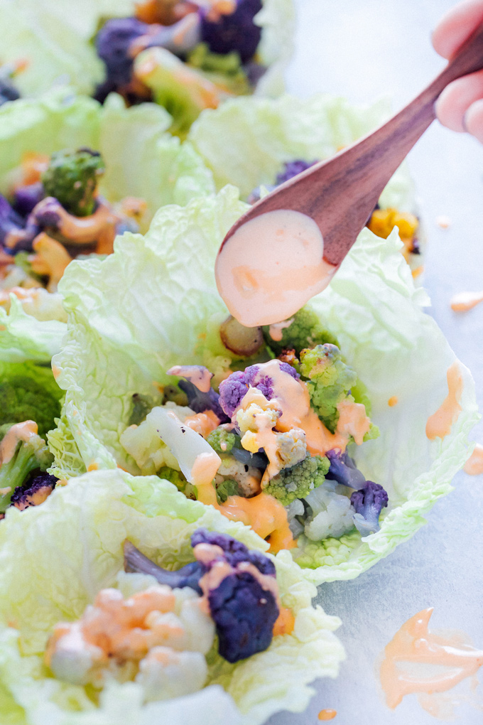 Roasted Cauliflower Cabbage Wraps - Rainbow cauliflower roasted then wrapped in savoy cabbage. Drizzle on some avocado cream or vegan thousand island dressing for added flavor. Super colorful, super delicious, super healthy. NeuroticMommy.com #cabbage #cauliflower #wraps #vegan