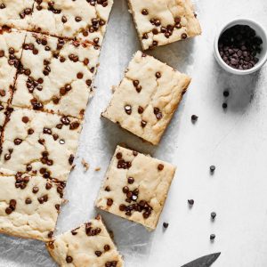 Vegan Sheet Pan Chocolate Peanut Butter Pancakes - Taking breakfast to a whole new level with these decked out pancake bars smothered with vegan white chocolate peanut butter and dazzled with dairy free chocolate chips. NeuroticMommy.com #vegan #pancakes #sheetpan