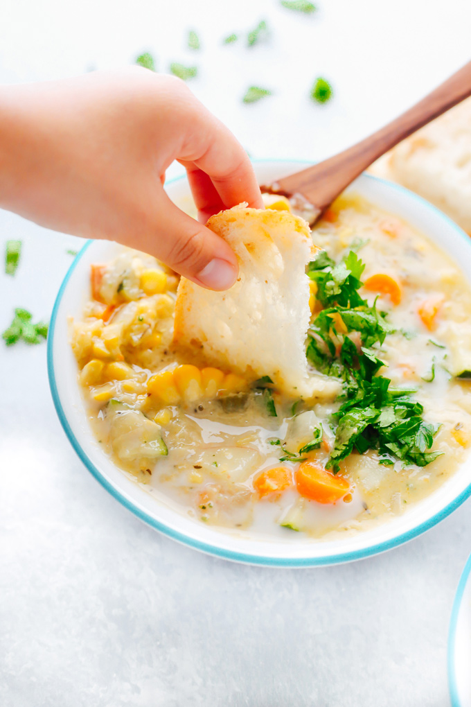 Creamy vegan chowder loaded with corn, zucchini and other herbs and veggies. This lightened up version is perfect for summer. NeuroticMommy.com #vegan