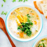 Creamy vegan chowder loaded with corn, zucchini and other herbs and veggies. This lightened up version is perfect for summer. NeuroticMommy.com #vegan