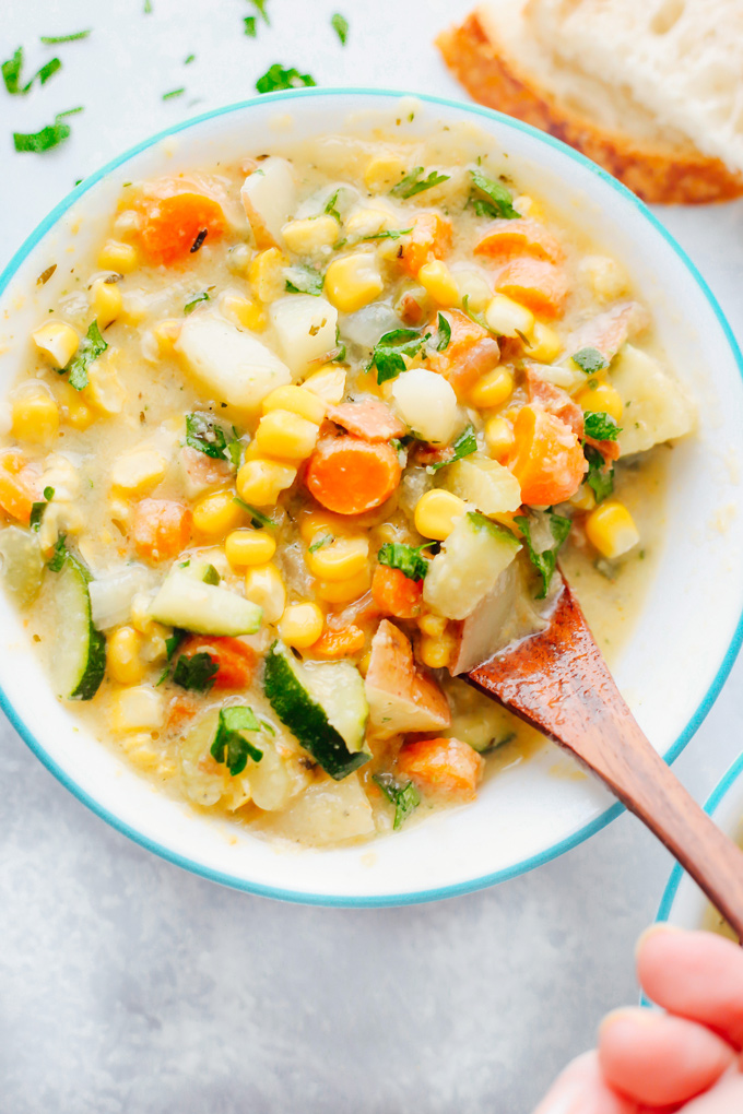 Creamy vegan chowder loaded with corn, zucchini and other herbs and veggies. This lightened up version is perfect for summer. NeuroticMommy.com #vegan