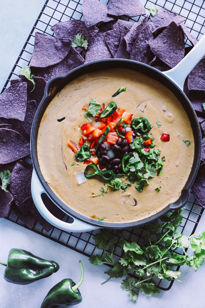 Vegan Poblano Black Bean Queso Dip is anything but basic. Loaded with all sorts of fresh goodness turned into a creamy, melty, luscious cheese dip perfect for all your dunking needs. NeuroticMommy.com #veganqueso