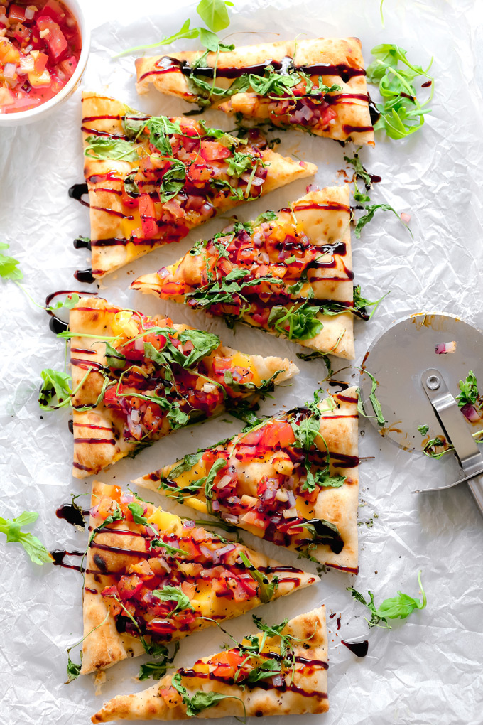 Vegan Bruschetta and Arugula Flatbread Pizza with a Balsamic glaze - Delicious easy recipe with immense flavor. Enjoy this homemade flatbread pizza using fresh bruschetta, arugula, vegan cheese, and a sweet balsamic glaze. NeuroticMommy.com #veganpizza