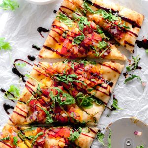 Vegan Bruschetta and Arugula Flatbread Pizza with a Balsamic glaze - Delicious easy recipe with immense flavor. Enjoy this homemade flatbread pizza using fresh bruschetta, arugula, vegan cheese, and a sweet balsamic glaze. NeuroticMommy.com #veganpizza