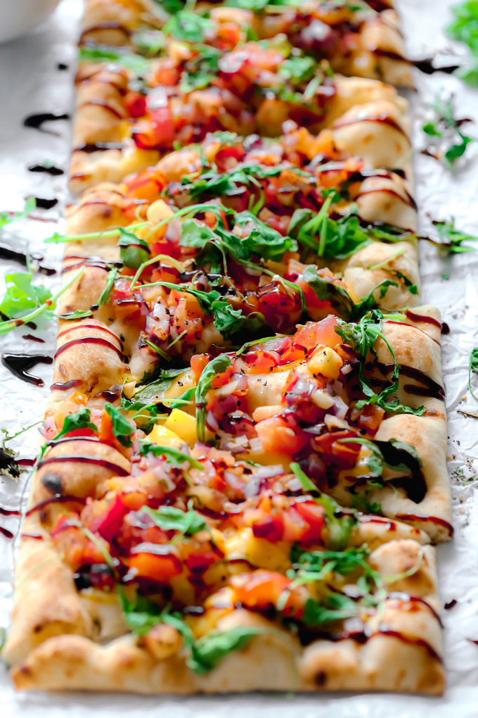 Vegan Bruschetta and Arugula Flatbread Pizza with a Balsamic glaze - Delicious easy recipe with immense flavor. Enjoy this homemade flatbread pizza using fresh bruschetta, arugula, vegan cheese, and a sweet balsamic glaze. NeuroticMommy.com #veganpizza