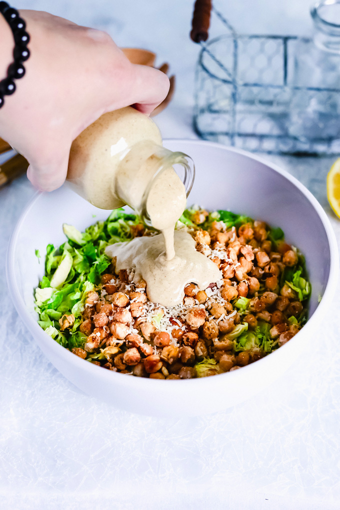 Vegan Brussels Sprout Caesar Salad with Chickpea Croutons - Such a fun way to enjoy a classic fave. With their anti-inflammatory properties brussels sprouts are one superfood to add to your weekly rotations. NeuroticMommy.com #vegan #caesarsalad #healthy