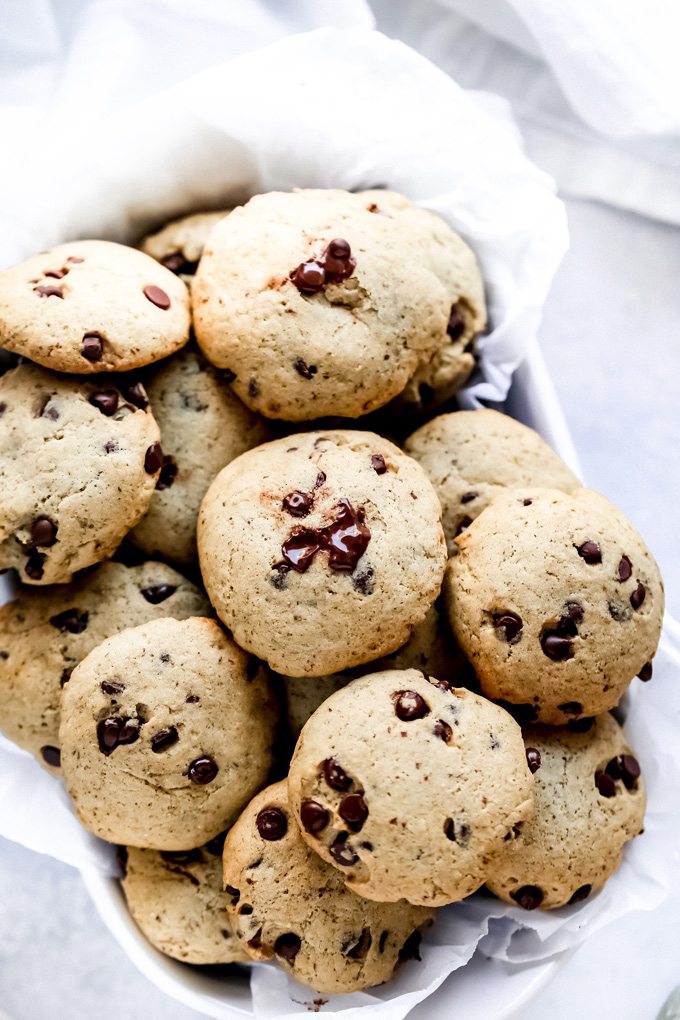 The Easiest Vegan Chocolate Chip Cookies - With a cake like center, these cookies have melty chocolate chips in every bite. No waiting for the dough to set, just whip these together with the easiest ingredients, enjoy raw or cooked and that's it! NeuroticMommy.com #vegancookies #chocolatechips #christmascookies