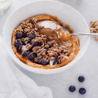 Vegan Sweet Potato Breakfast Bowl - Topped with blueberries, almond butter, and dairy free yogurt, this is packed with fiber, healthy fats and so easy to make! You can meal prep this and have it ready to go with all the right ingredients to fuel your day! NeuroticMommy.com #vegan #breakfast #sweetpotatoes