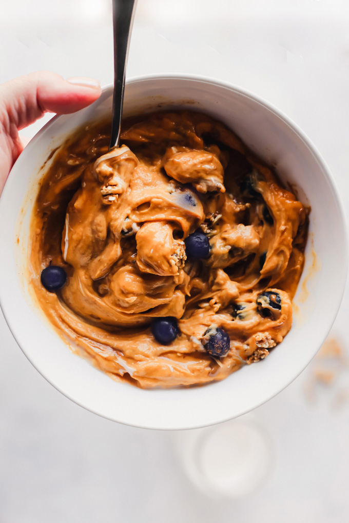 Vegan Sweet Potato Breakfast Bowl - Topped with blueberries, almond butter, and dairy free yogurt, this is packed with fiber, healthy fats and so easy to make! You can meal prep this and have it ready to go with all the right ingredients to fuel your day! NeuroticMommy.com #vegan #breakfast #sweetpotatoes