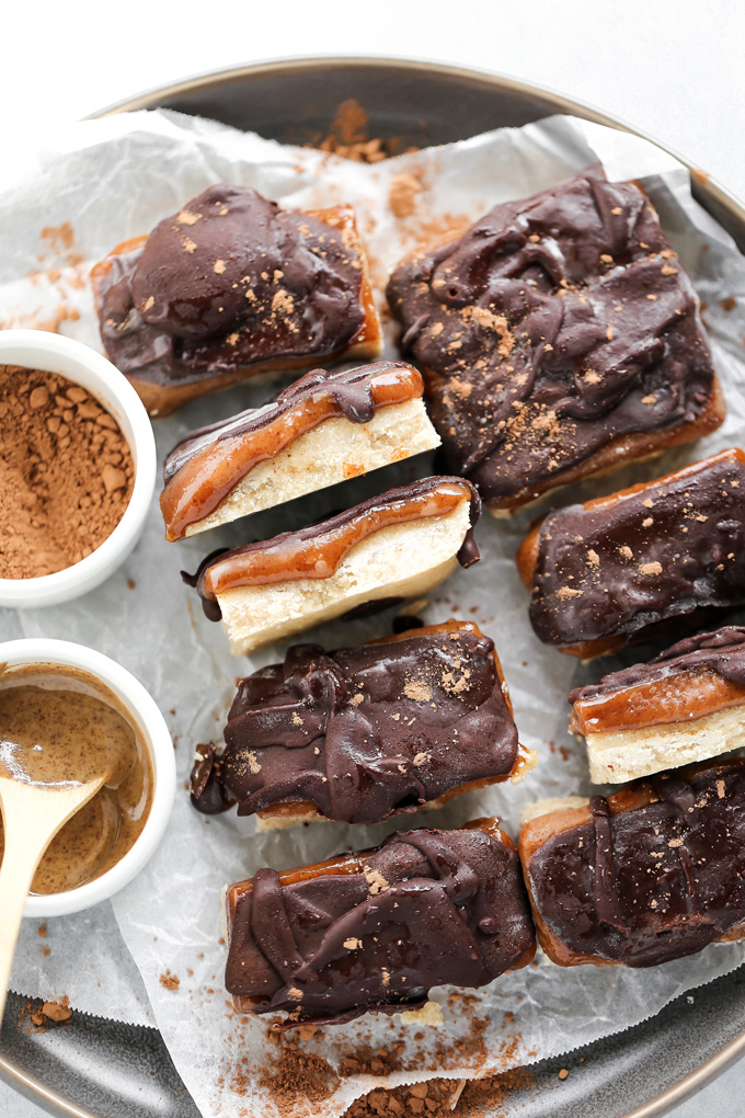 Homemade Vegan Twix Bars - A traditional shortbread crust layered with gooey caramel filling and a sweet dark chocolate topping. A delicious vegan remake to a classic recipe. NeuroticMommy.com #vegantwix
