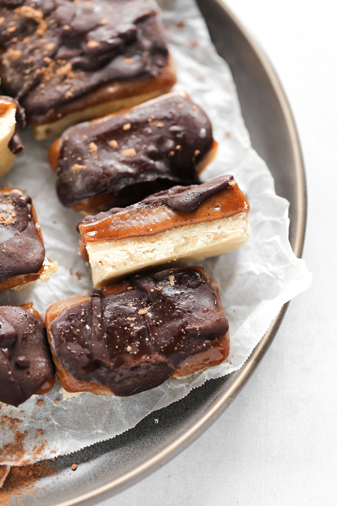 Homemade Vegan Twix Bars - A traditional shortbread crust layered with gooey caramel filling and a sweet dark chocolate topping. A delicious vegan remake to a classic recipe. NeuroticMommy.com #vegantwix