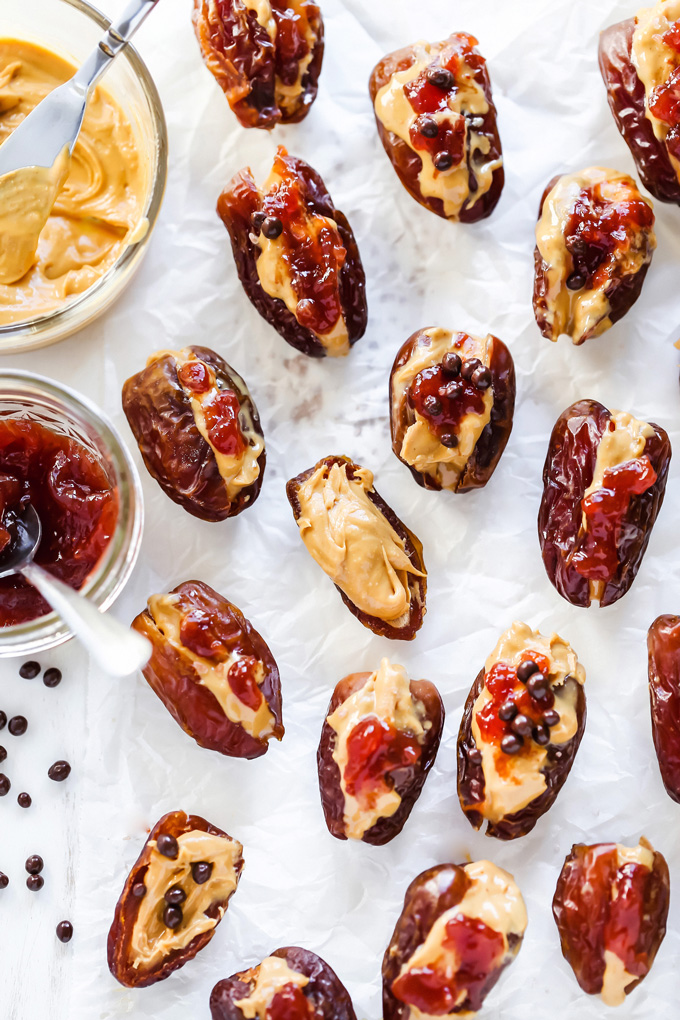 Peanut Butter and Jelly Stuffed Dates - Filled with creamy peanut butter and sweet strawberry jam, these are THE snack to have. Jam packed with goodness. NeuroticMommy.com #healthysnacks #stuffeddates