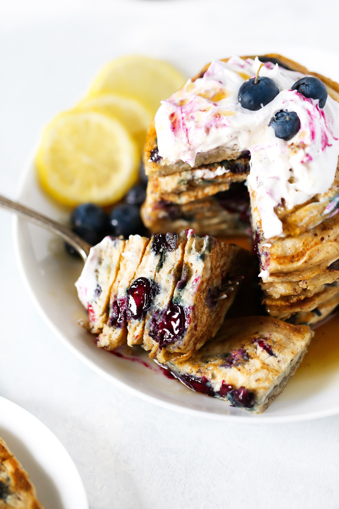 Vegan Blueberry Lemon Buttermilk Pancakes - The BEST VEGAN Fluffy Buttermilk Pancakes you'll ever try! With blueberries and lemon in every bite and topped with coconut whip cream, maple syrup and a blueberry compote. NeuroticMommy.com #vegan #pancakes