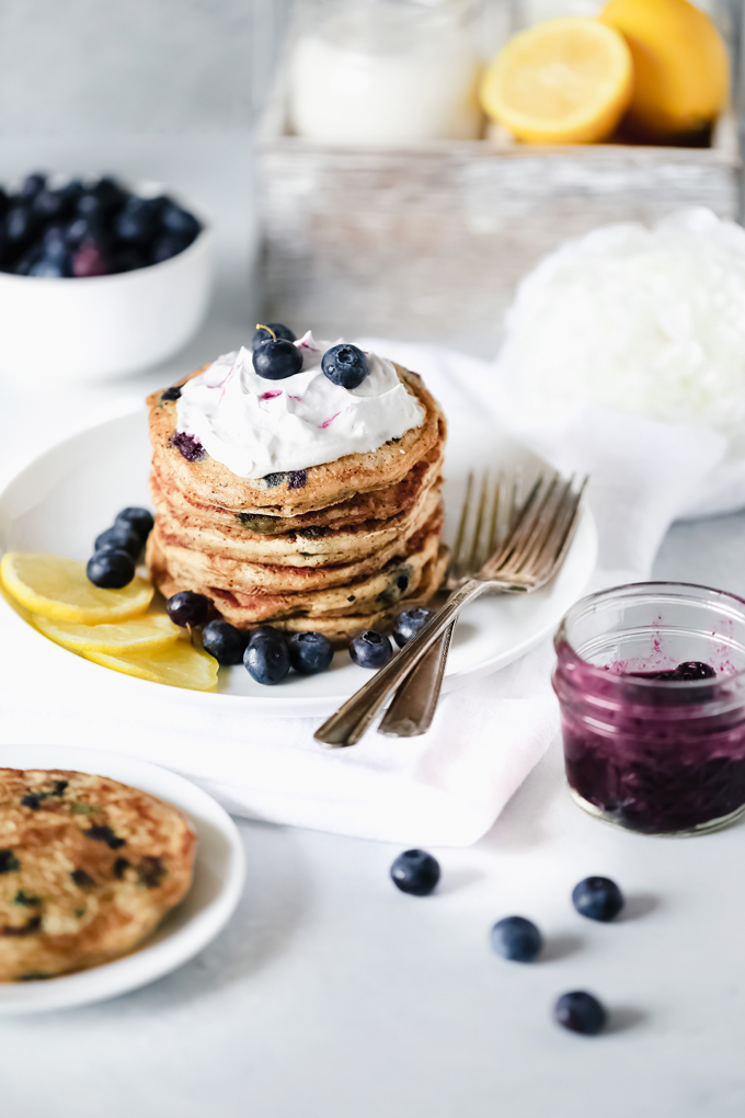 Vegan Blueberry Lemon Buttermilk Pancakes - The BEST VEGAN Fluffy Buttermilk Pancakes you'll ever try! With blueberries and lemon in every bite and topped with coconut whip cream, maple syrup and a blueberry compote. NeuroticMommy.com #vegan #pancakes