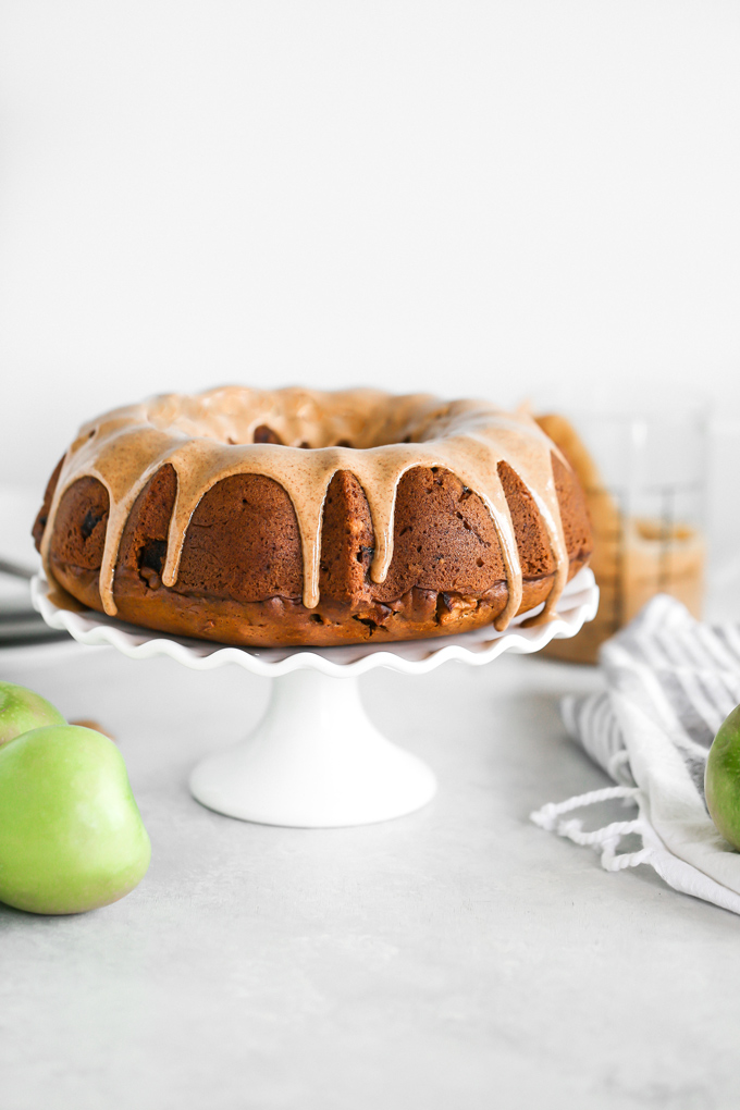 Almond Butter Apple Pudding Bundt Cake tastes like pudding, it's super fluffy and light with the perfect almond butter, date, caramel drizzle, making this all sorts of delicious. And it's Vegan. NeuroticMommy.com #vegancake