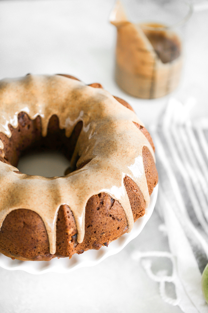 Almond Butter Apple Pudding Bundt Cake tastes like pudding, it's super fluffy and light with the perfect almond butter, date, caramel drizzle, making this all sorts of delicious. And it's Vegan. NeuroticMommy.com #vegancake