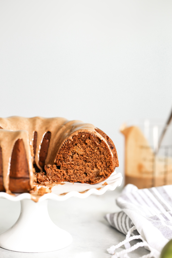 Almond Butter Apple Pudding Bundt Cake tastes like pudding, it's super fluffy and light with the perfect almond butter, date, caramel drizzle, making this all sorts of delicious. And it's Vegan. NeuroticMommy.com #vegancake