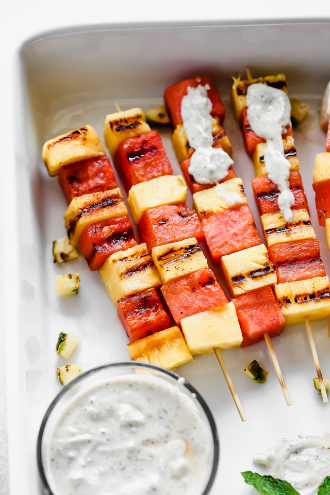 Grilled Watermelon and Pineapple Skewers - Juicy and sweet pineapple and watermelon grilled to perfection then drizzled in a refreshing Vegan Tzatziki sauce bringing you all the tropical, summer feels. NeuroticMommy.com #vegan #summersnacks