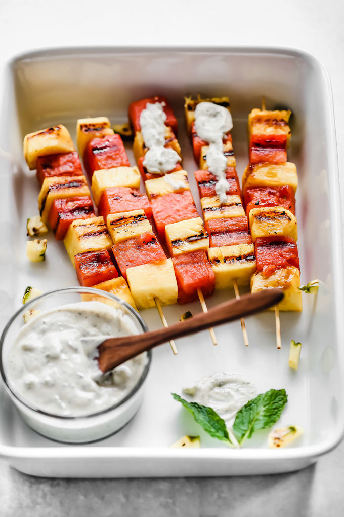 Grilled Watermelon and Pineapple Skewers - Juicy and sweet pineapple and watermelon grilled to perfection then drizzled in a refreshing Vegan Tzatziki sauce bringing you all the tropical, summer feels. NeuroticMommy.com #vegan #summersnacks