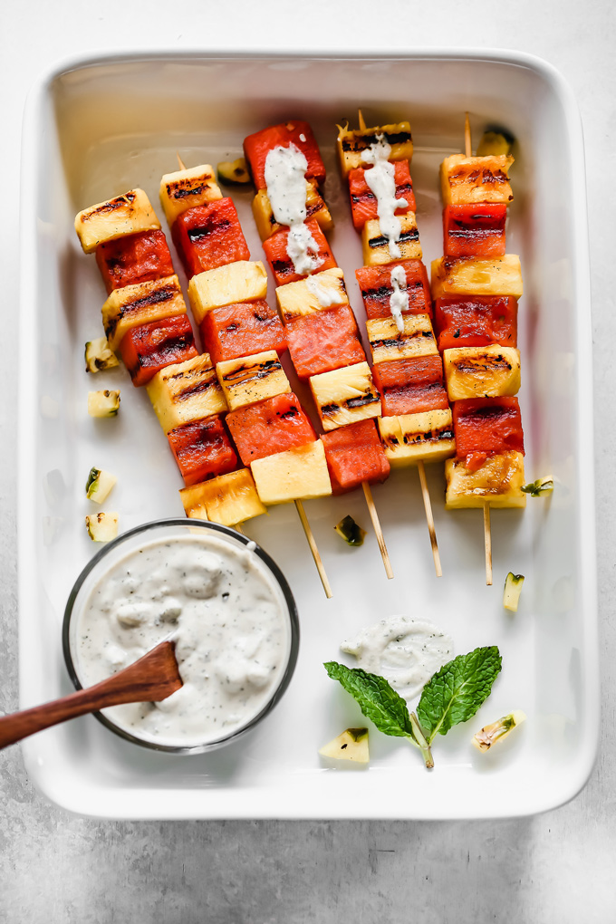 Grilled Watermelon and Pineapple Skewers - Juicy and sweet pineapple and watermelon grilled to perfection then drizzled in a refreshing Vegan Tzatziki sauce bringing you all the tropical, summer feels. NeuroticMommy.com #vegan #summersnacks