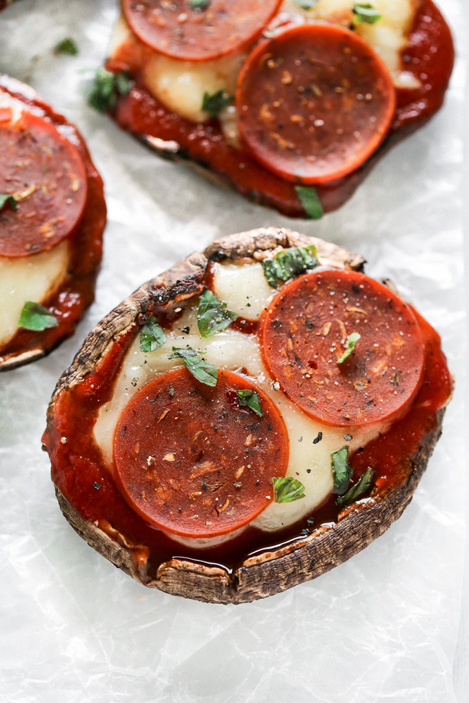 Vegan Keto Portobello Mushroom Pizzas are stuffed with vegan mozzarella, a keto friendly marinara sauce thats sugar free and topped with vegan pepperoni and sprinkles of basil. Perfect for your keto meals and hits the spot with pizza cravings! NeuroticMommy.com #keto #vegan