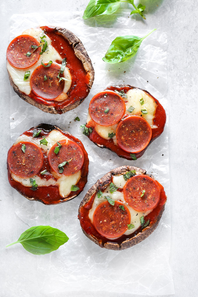 Vegan Keto Portobello Mushroom Pizzas are stuffed with vegan mozzarella, a keto friendly marinara sauce thats sugar free and topped with vegan pepperoni and sprinkles of basil. Perfect for your keto meals and hits the spot with pizza cravings! NeuroticMommy.com #keto #vegan