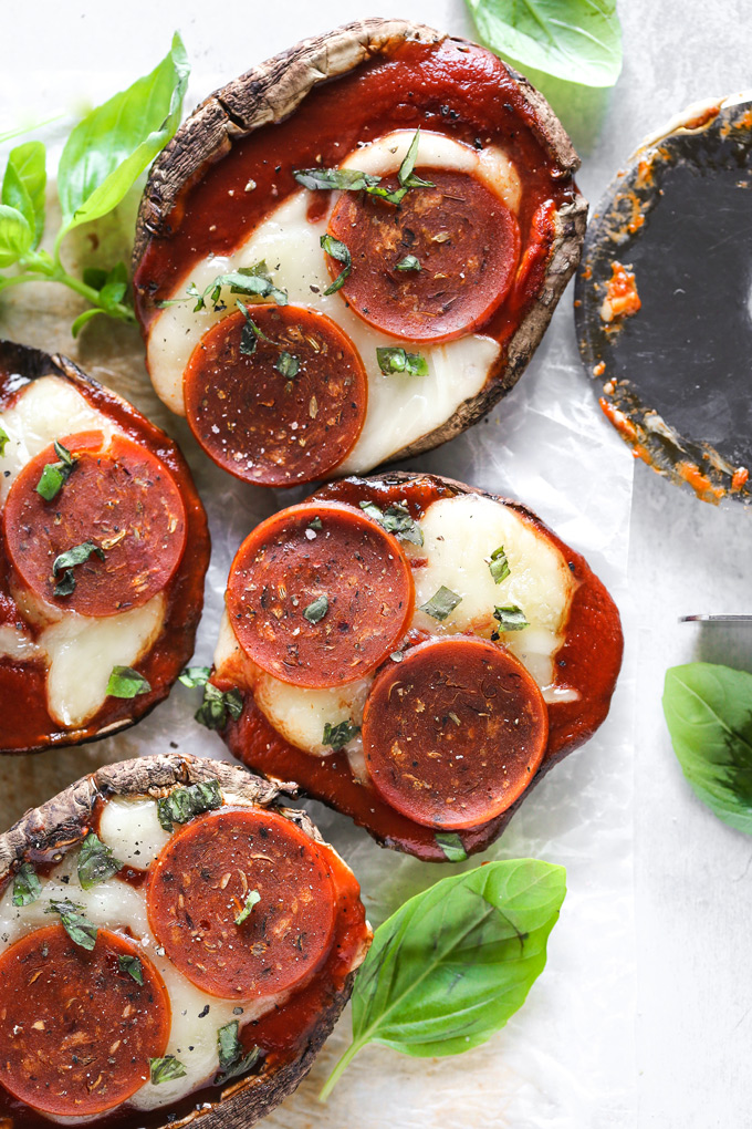 Vegan Keto Portobello Mushroom Pizzas are stuffed with vegan mozzarella, a keto friendly marinara sauce thats sugar free and topped with vegan pepperoni and sprinkles of basil. Perfect for your keto meals and hits the spot with pizza cravings! NeuroticMommy.com #keto #vegan